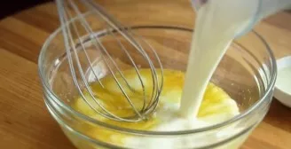 Add sugar and a pinch of salt to eggs, whisk with a whisk. Then pour in the milk.