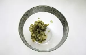 Finely chop two small pickled cucumbers and put in a salad bowl.