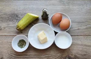 Prepare all the necessary ingredients for an omelet with zucchini.
