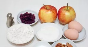Prepare all the ingredients needed to make a quick apple roll with cranberries.
