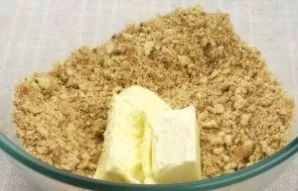 Mix the crushed cookies with melted butter.