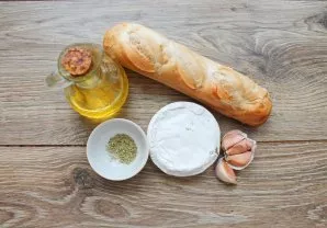 Prepare all the necessary ingredients for making camembert with a baguette.