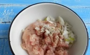 Chop the onion and mix it with the ground chicken in a bowl. Add salt and pepper to taste.