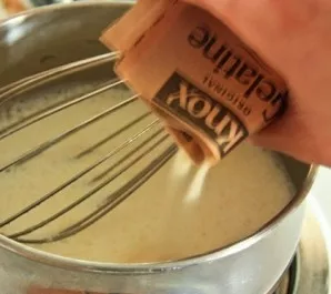 We take a small pot, mix milk and 2 packets of gelatin in it.