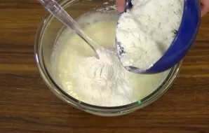 Beat eggs with a mixer with sugar into a fluffy mass. Add refined vegetable oil and beat again. Mix the sifted flour with baking powder a...