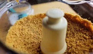 Grind cookies together with nuts into crumbs. Preheat oven to 180 degrees.