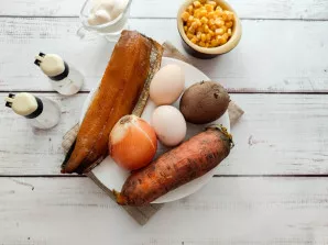 Prepare all the necessary ingredients. Boil the potatoes and carrots until tender and let them cool completely. Boil the eggs for 7-8 min...