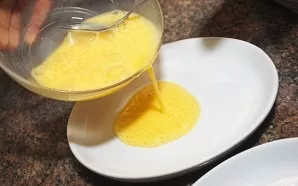 Beat the eggs. Pour them into a flat container. This will make it easier to immerse chicken nuggets.