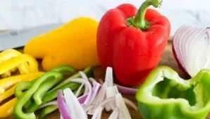 Cut the onion into strips, clean the pepper, wash and cut into strips. Cut the tomatoes into cubes, finely chop the garlic with a sharp k...