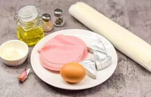 Prepare all the necessary ingredients. Boil the eggs for 12 minutes. Cool the eggs and peel them. Preheat the oven and set the temperatur...