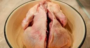 Wash the hen, clean it well and cut it along the back.