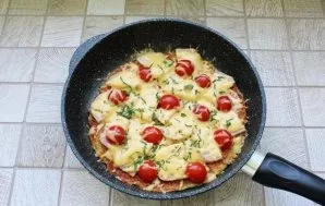 Return the pizza pan on the stove, cover and let the cheese melt.