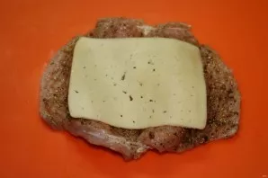 Put a slice of cheese on each steak.