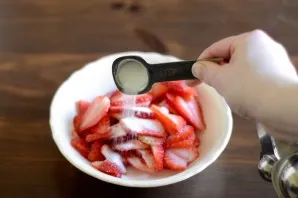 While the ice cream is in the cooking machine, finely chop the remaining strawberries, sprinkle with sugar and put in the freezer.