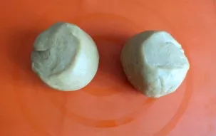 After the time has passed, remove the dough from the refrigerator. Divide it into two equal parts.