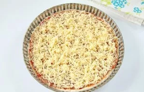 Sprinkle the pizza with grated cheese and bake at 240 degrees for about 10 minutes