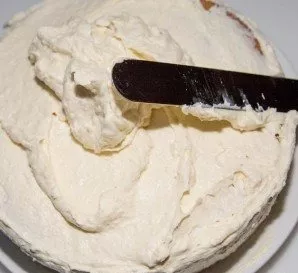 Do the same with all the layers, spread the cream liberally on the top layer without adding almonds and wafers. Grease the edges of the b...