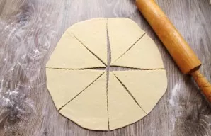 Put the dough on a table sprinkled with flour, divide it into two balls. Cover and let stand for 10 minutes. Roll each ball into a 0.7 mm...