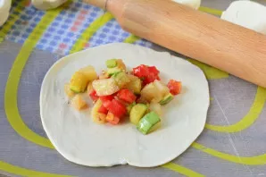 Roll out each piece thinly and lay out a spoonful of vegetable filling.