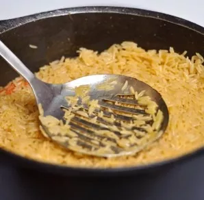 Put the head of garlic back. When the rice starts to absorb the water, remove the garlic again. Cover the pilaf and cook for 8 minutes. C...