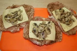 Put the mushrooms on top of the cheese.