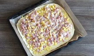 Line the baking sheet with baking paper. Lay one layer on a baking sheet. Spread the filling on top of the layer. Smooth it out.