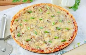 Onion pizza is ready. Cut into portions and serve.