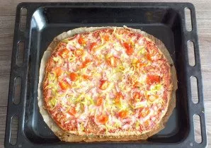 After the time has passed, take the pizza out of the oven.