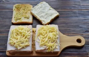 Put two slices of ham on top of the grated cheese and spread a handful of grated cheese again. Coat the remaining bread toast with French...