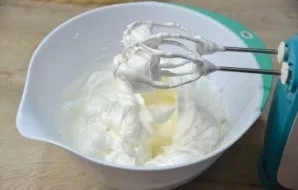 In a thin stream, trying not to get on the whisk blades, pour the syrup into the whipped whites, continuing to beat until thick. The crea...
