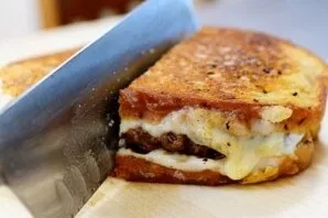 Cut the prepared sandwich in half and serve hot. Enjoy your meal!