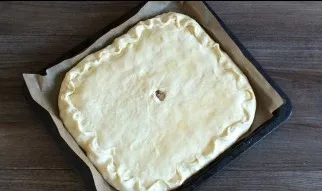 Close with the second layer, press the edges. Brush the top with an egg. Place the baking sheet in an oven preheated to 180 degrees for 3...