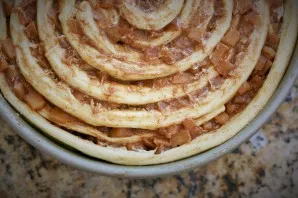 Wrap the other around the previous one. This is how you can make a sweet cake from yeast dough. Squeeze the top with your hands and bake ...