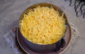 Grate the cheese on top of the egg layer.