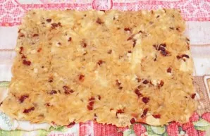 Dampen a clean towel and dry well. Spread the towel on the table and turn the biscuit so that the paper is on top. Wipe the surface of th...