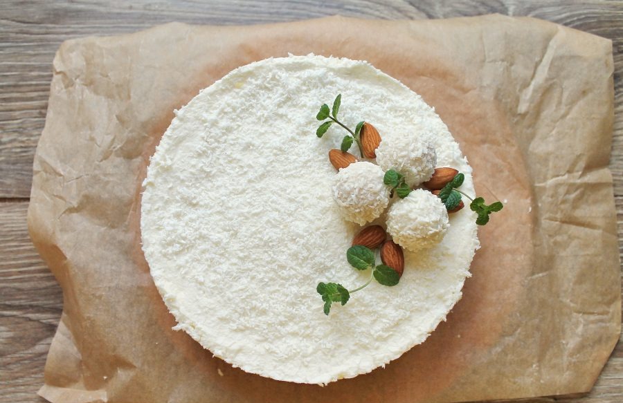 Decorate the top of the cheesecake with shredded coconut, candy and fresh mint.