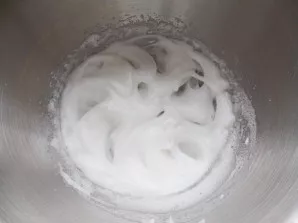 Pour two egg whites into a clean, cold bowl, add a pinch of salt and beat until stiff.