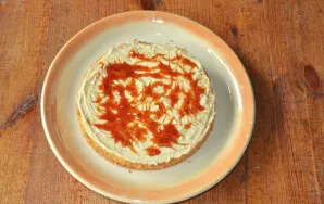 Coat the second layer of biscuit with the remaining cream, and decorate the top with caramel sauce.