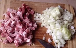 In the meantime, lets make a sauce. Chop the bacon and onion.