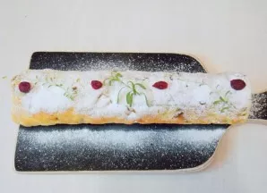 Unfold the towel and place the roll on a cutting board, seam side down. Sprinkle with powdered sugar and decorate as desired.