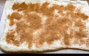 Evenly distribute the mixture of brown sugar and cinnamon on a thin layer of butter.
