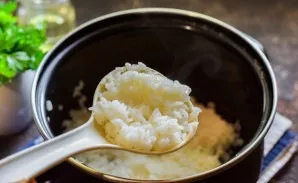 Transfer the rice to a saucepan, pour one and a half servings of water and boil the rice until half cooked - 12-15 minutes over low heat.