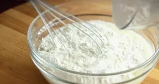 Add the sifted flour in several stages and mix so that there are no lumps, add oil and mix again. The dough should stand for 15 minutes a...