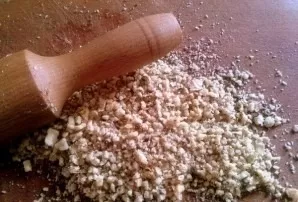 While the dough defrosts, prepare the filling: chop the nuts with a rolling pin.
