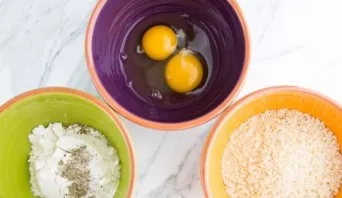 Lay out in wide bowls: eggs, flour with pepper and breadcrumbs.