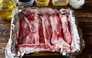 Place the ribs in a baking dish lined with foil.
