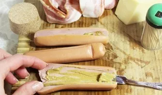 First you need to peel the sausages and carefully, but not completely, cut them. We coat with sauce to taste. If desired, you can add a l...