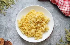 Boil the pasta in salted, boiling water until almost cooked. Put them in a sieve and let the water drain completely.