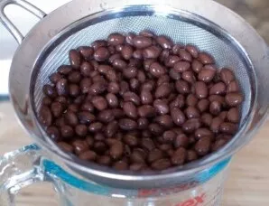 Put the canned beans in a colander so that all the liquid drains from the beans. It is not enough just to drain the liquid from the jar, ...