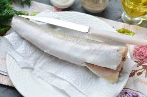 Defrost, wash and clean the hake.